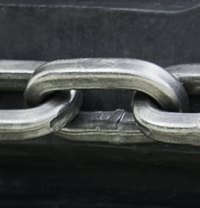 Square link chain on black tire